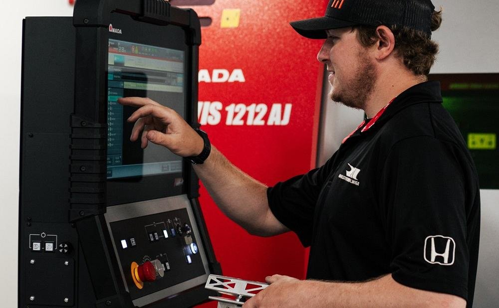 A man touches a computer screen.