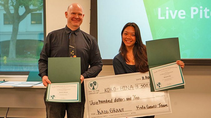 people smiling with a certificate and large check