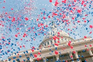 Red, White, and Blue Balloons Over the U.S. Capitol Building