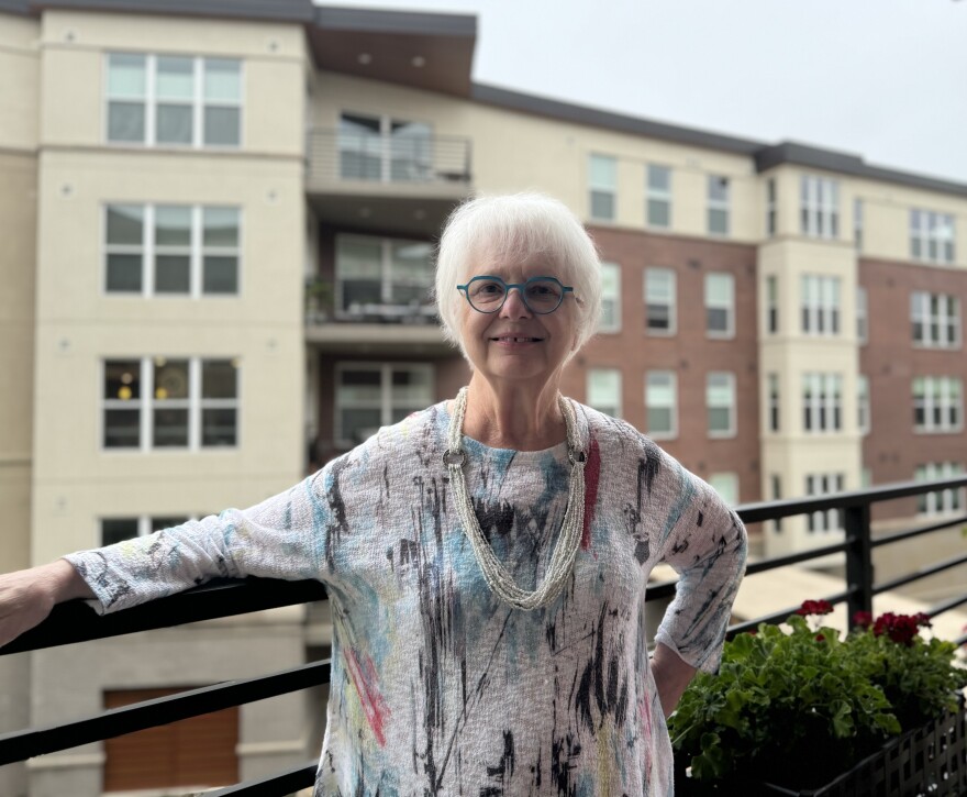 Jo Ferguson poses on her porch at Frasier, a retirement community in Boulder that had its power cut during a planned outage conducted to avoid a wildfire. 