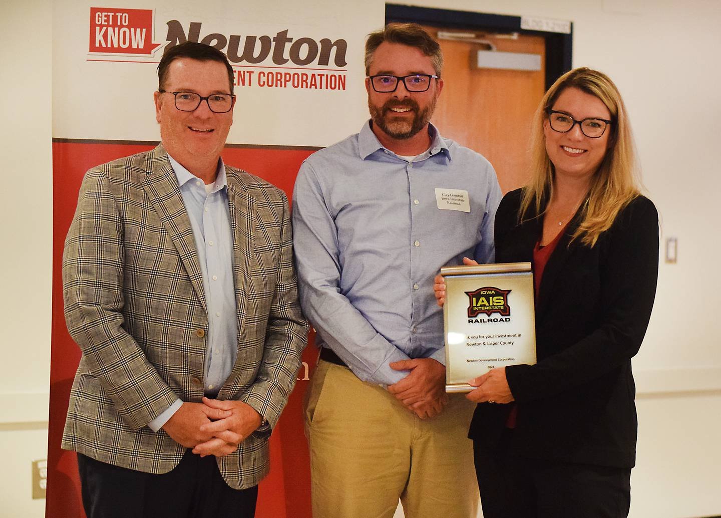 Clay Gambill and Carrie Evans shows of Iowa Interestate Railroad off the award they received from Newton Development Corporation during its Salute to Business and Industry luncheon on Oct. 10 in DMACC Newton Campus.