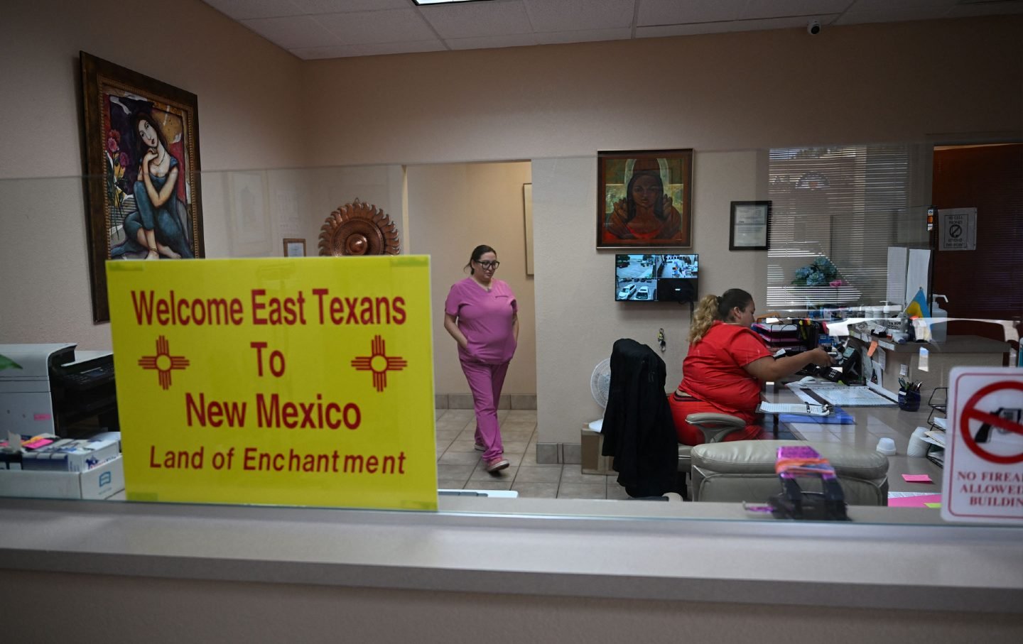 A sign welcoming patients from East Texas is displayed in the waiting area of the Women's Reproductive Clinic, which provides legal medication abortion services, in Santa Teresa, New Mexico.